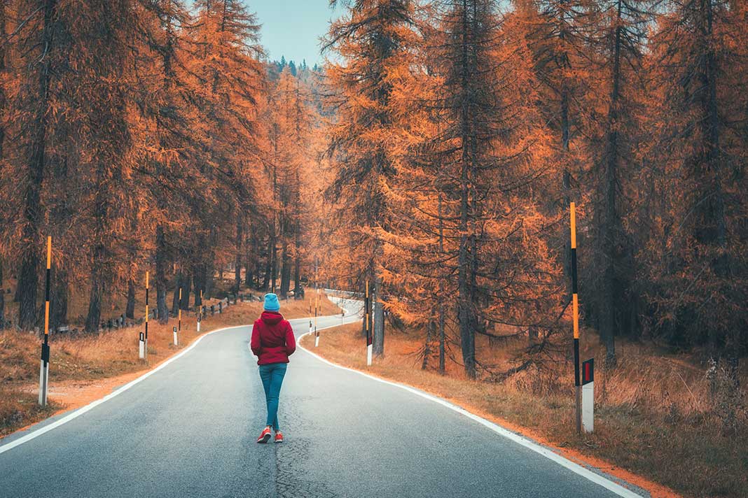 Woman walking on a winding road
